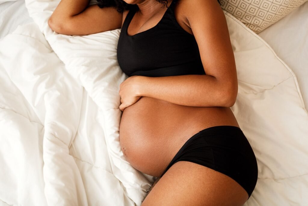 unrecognizable pregnant woman lying on a bed royalty free image 1577127939
